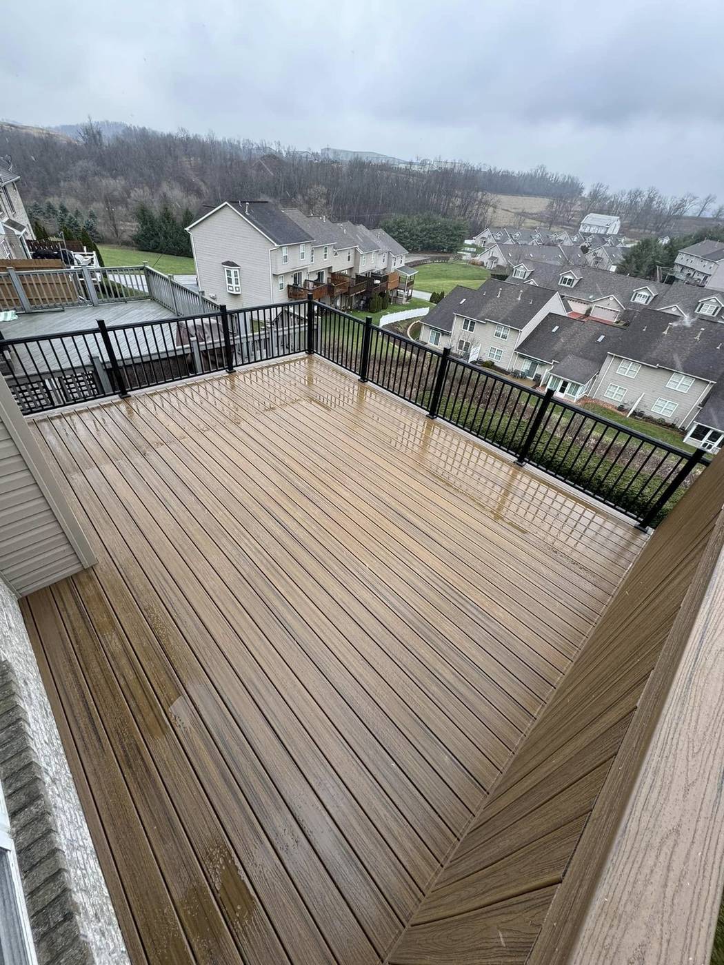 Havana Gold Trex deck with black aluminum railing overlooking the neighborhood
