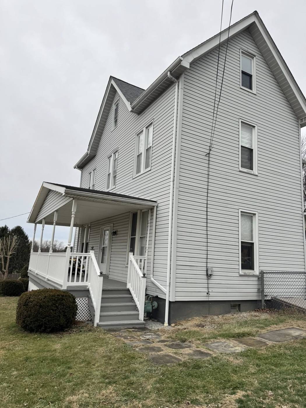 Home before siding replacement — faded white siding